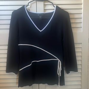 A black and white cable and gauge blouse.
